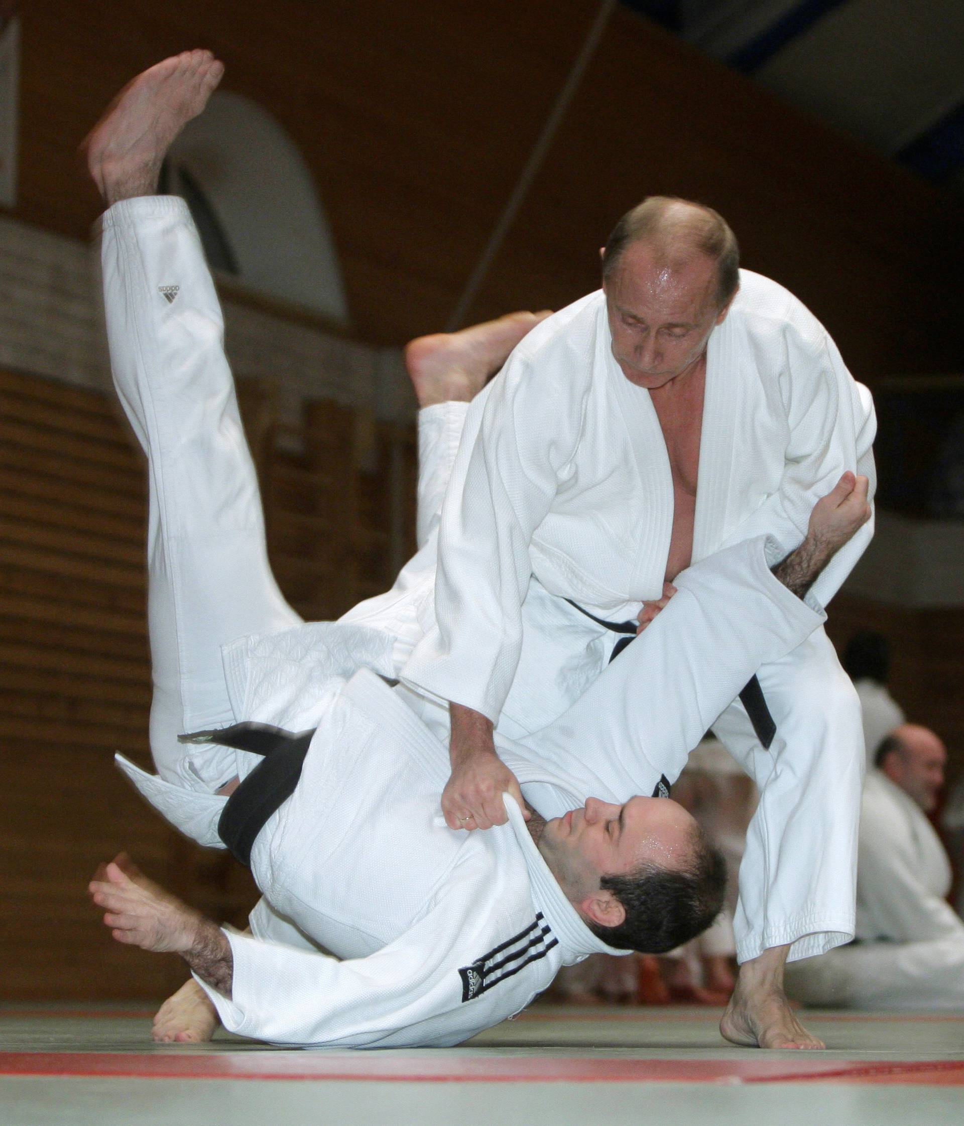 FILE PHOTO: Russia's Prime Minister Vladimir Putin attends a judo training session at Top Athletic School in St. Petersburg