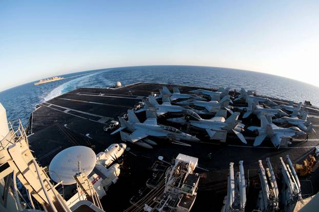 The Nimitz-class aircraft carrier USS Abraham Lincoln breaks away from the fast combat support ship USNS Arctic after an underway replenishment-at-sea in the Mediterranean Sea