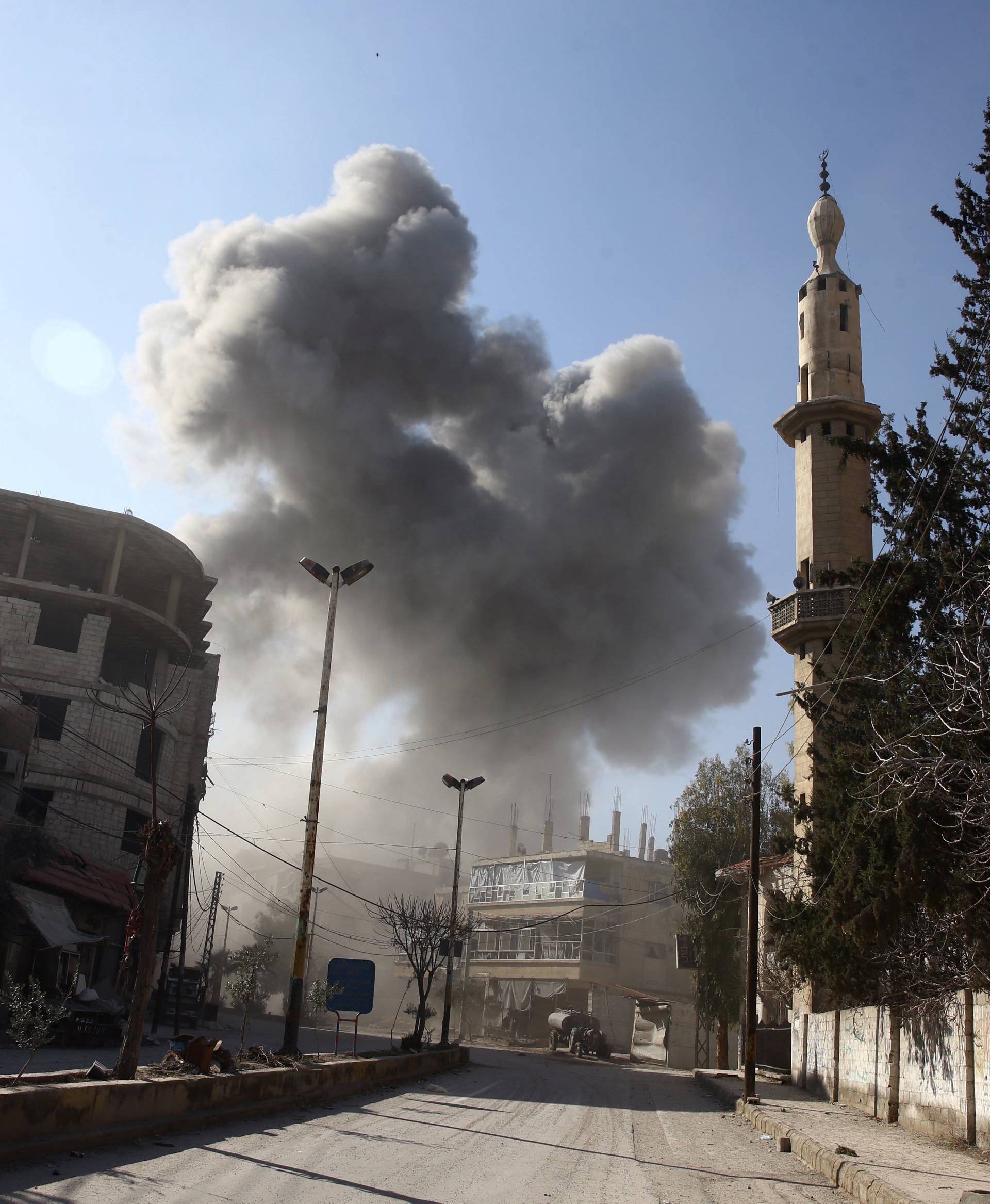 Smoke rises from the rebel held besieged town of Hamouriyeh
