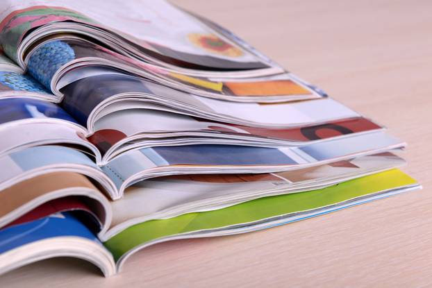 Magazines on wooden table close up