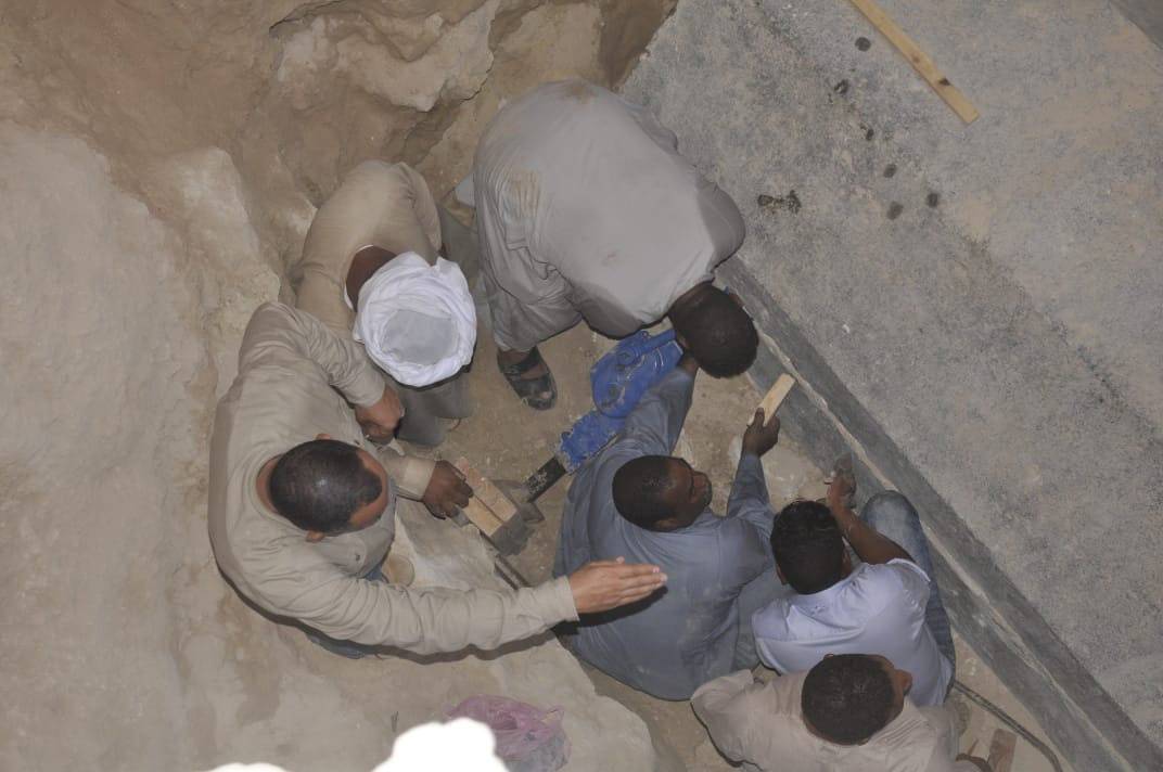 Egyptian excavation workers labor outside the site of the newly discovered giant black sarcophagus in Sidi Gaber district of Alexandria