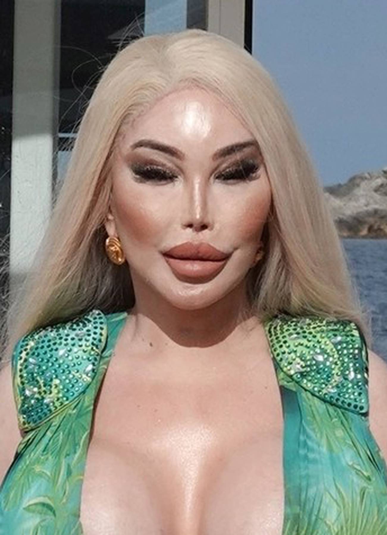 Former Human Ken doll Jessica Alves is pictured showing off her surgically enhanced cleavage while enjoying lunch in Ibiza.