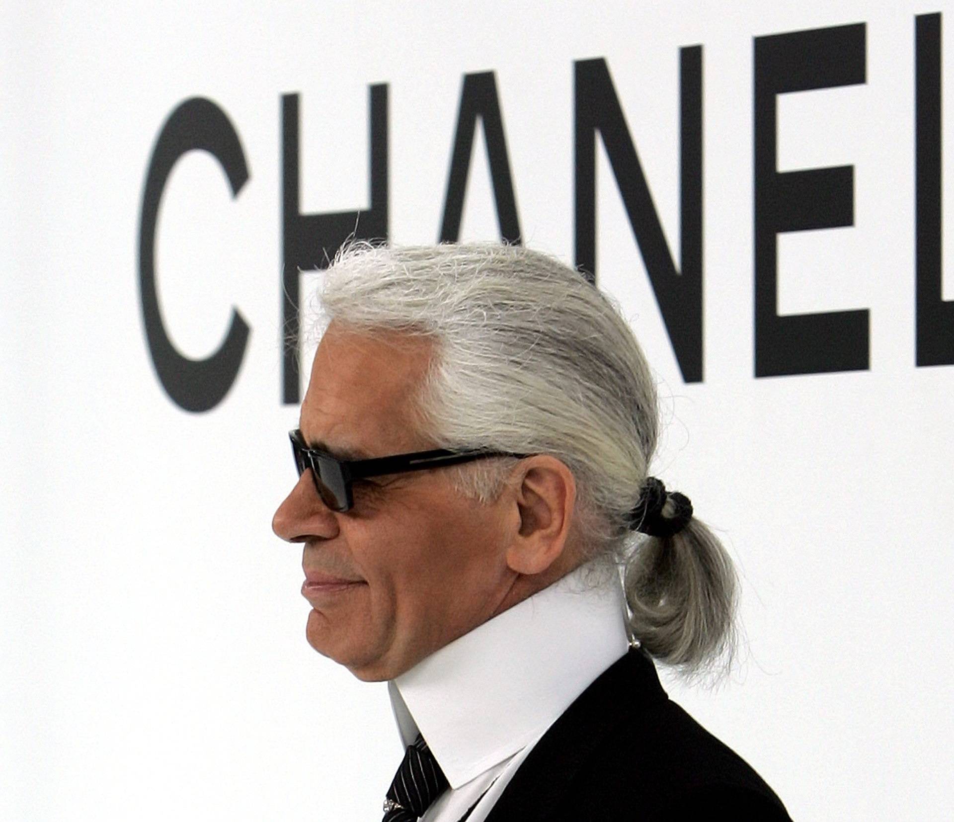 FILE PHOTO -  German designer Karl Lagerfeld appears on the catwalk after his Autumn/Winter 2004/2005 high fashion collection for the Chanel fashion house in Paris