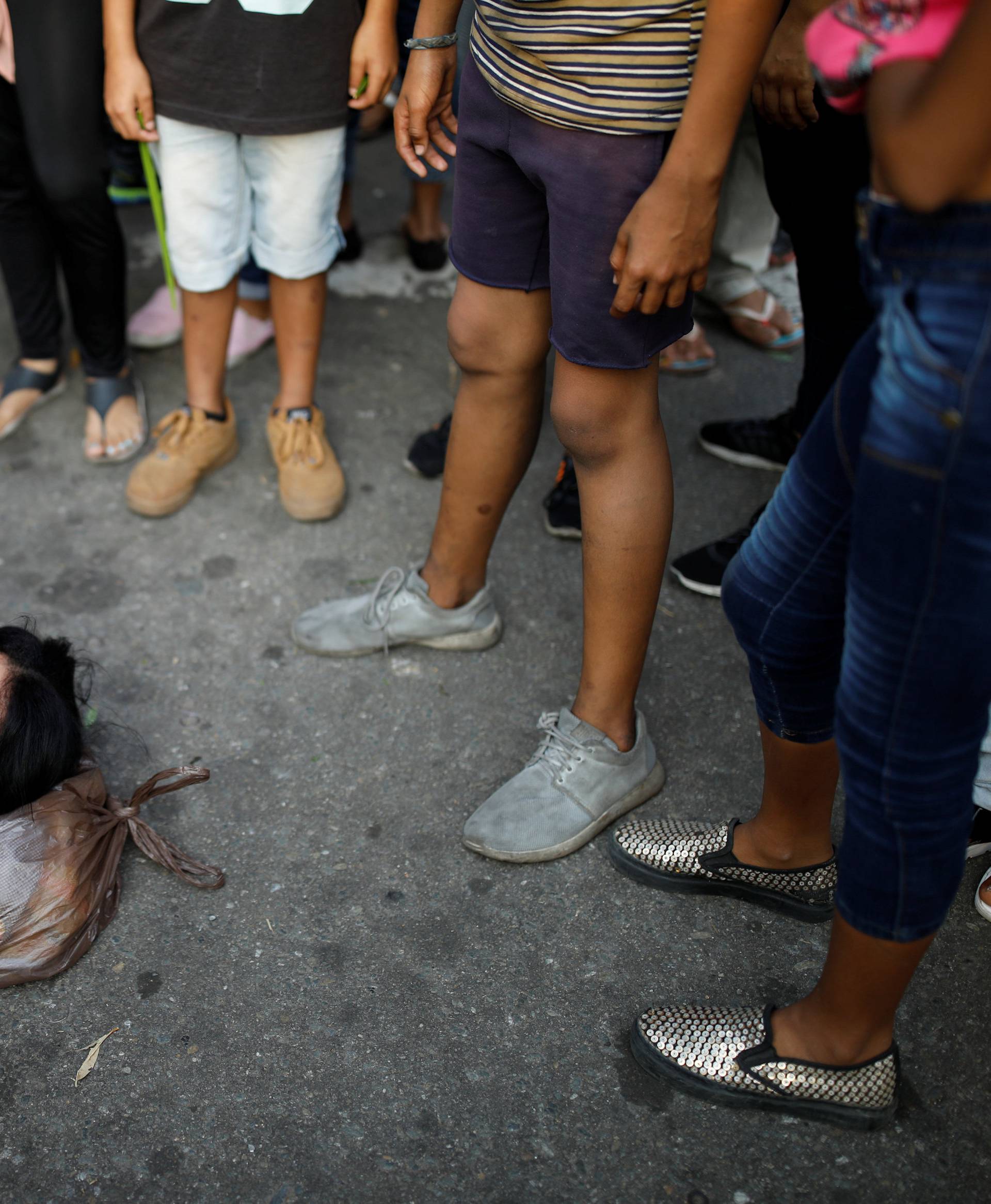 A relative of inmates at the General Command of the Carabobo Police faints outside the prison where a fire occurred in Valencia