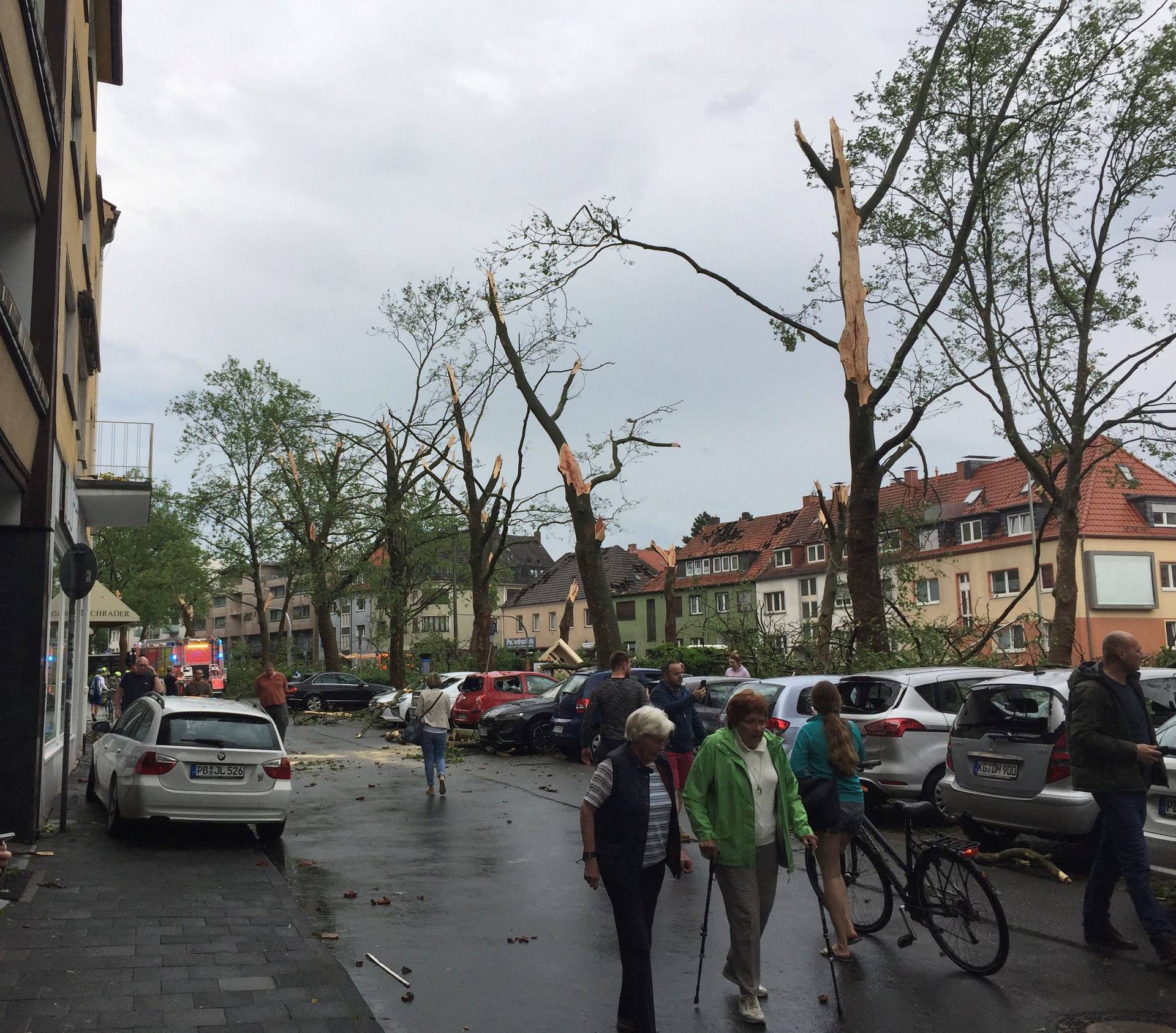 People walk on the streets in the aftermath of a tornado that swept through the town of Paderborn