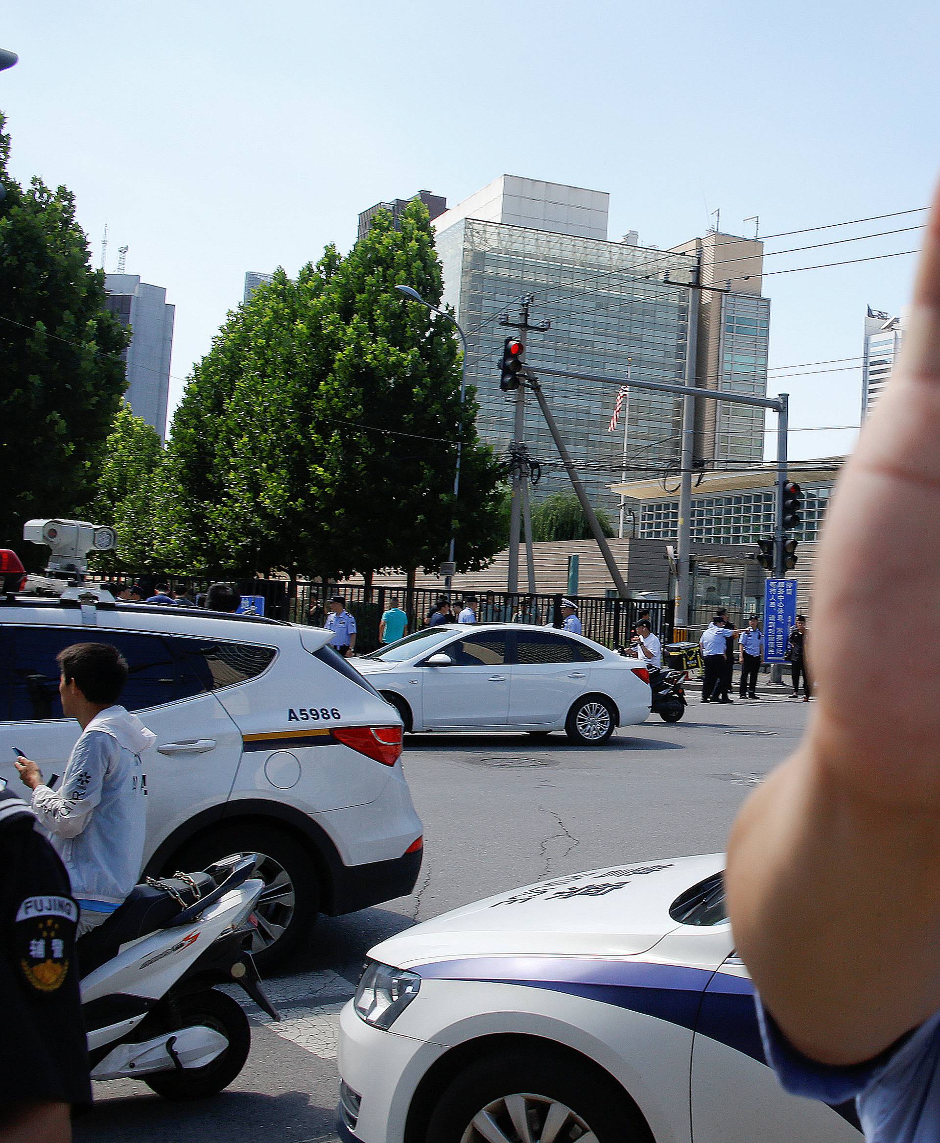 A police officer gestures near the site of a blast outside the U.S. embassy in Beijing