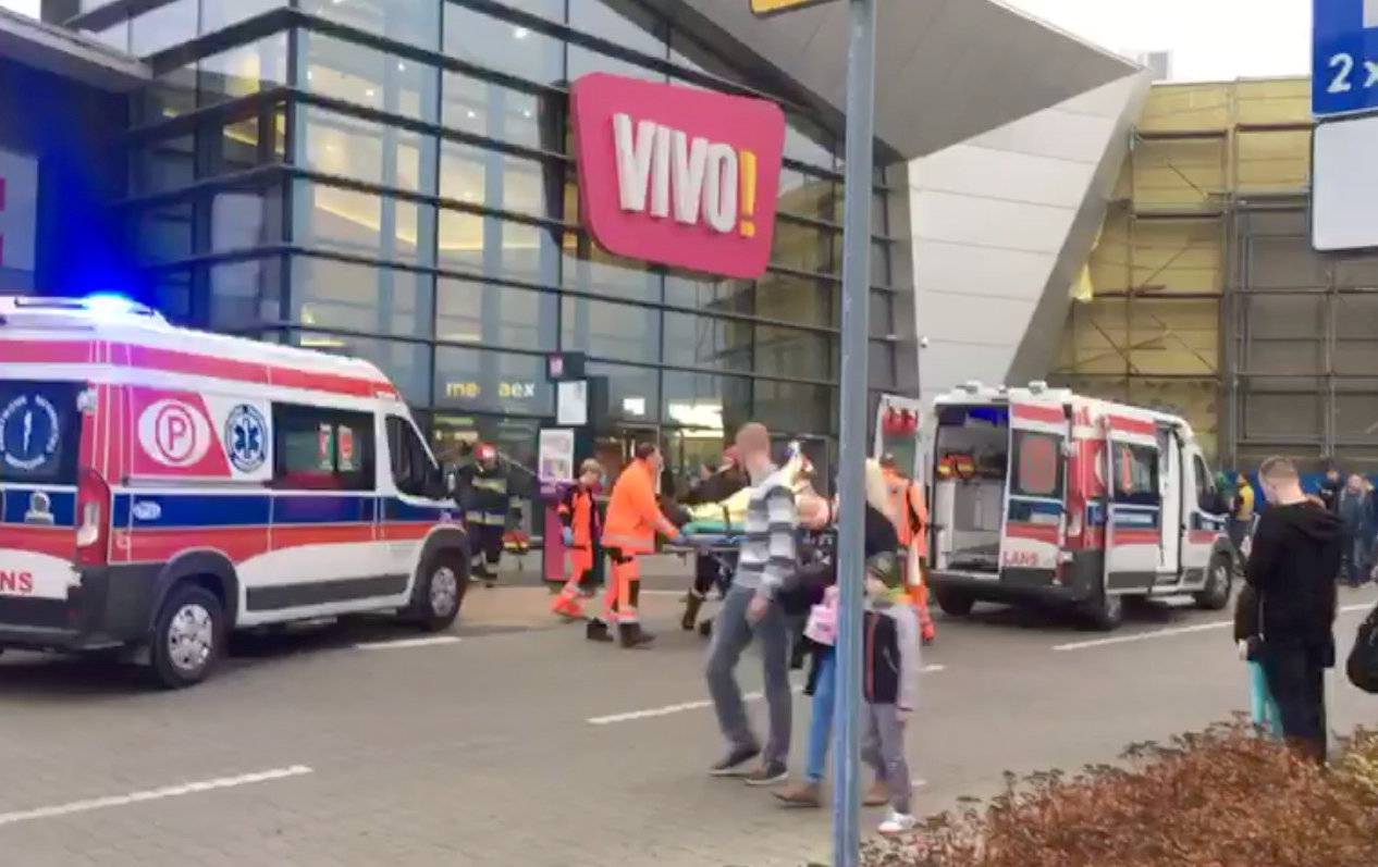 Emergency services transport a victim to an ambulance following an attack at a mall in Stalowa Wola, Poland