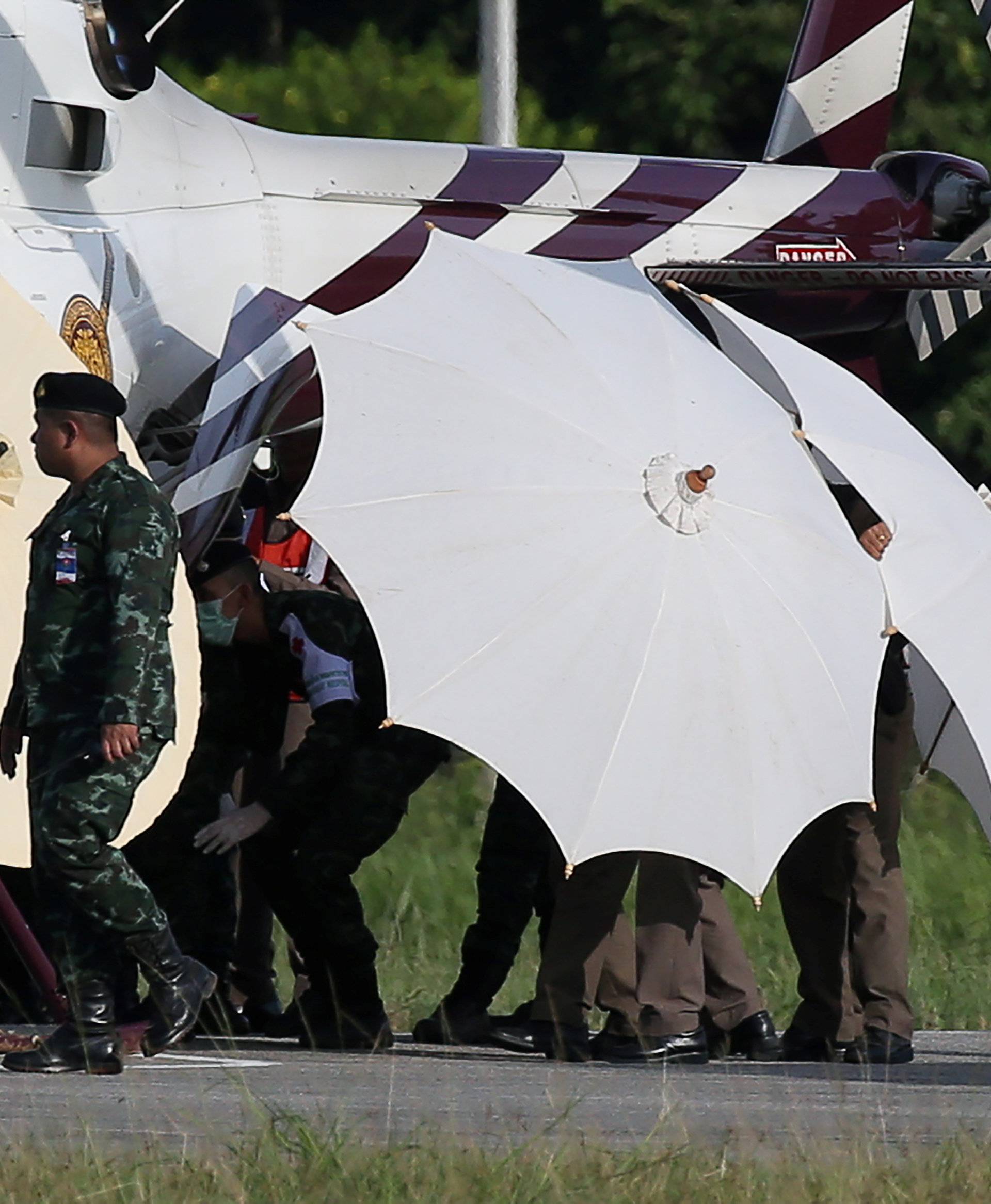 Rescued schoolboys are moved from a Royal Thai Police helicopter to an awaiting ambulance at a military airport in Chiang Rai