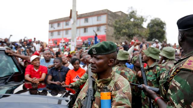 Policemen guard as Kenya's President Uhuru Kenyatta addresses supporters at Burma market after his election win was declared invalid by the Supreme Court in Nairobi