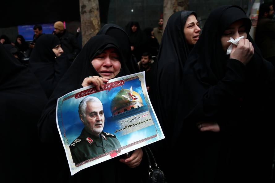 Iranian women react as they gather to mourn General Qassem Soleimani in Tehran