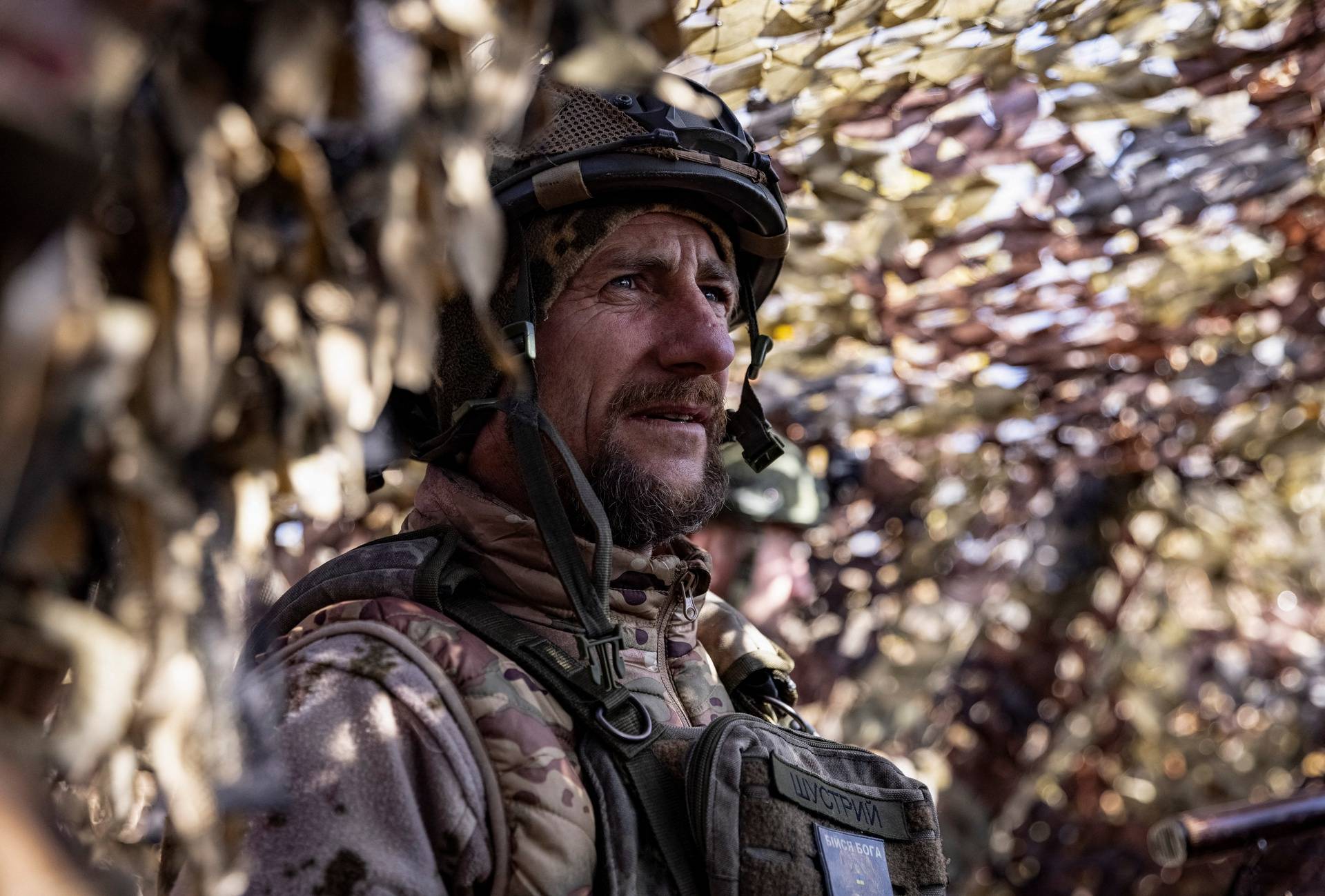 A Ukrainian serviceman looks on at a position near a frontline in Donetsk region