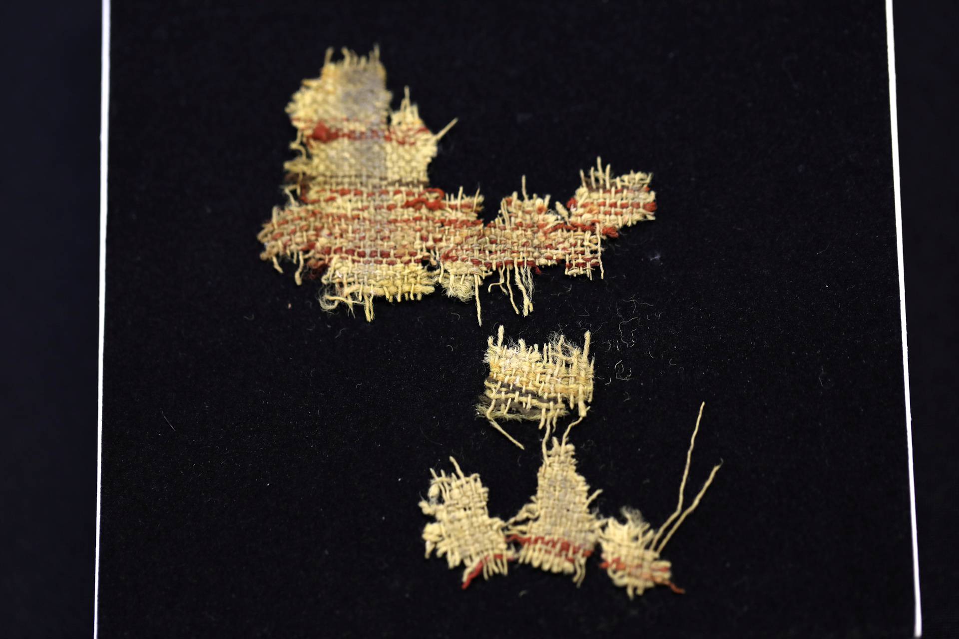 Woven fabric, part of various ancient artefacts recently discovered in the Judean Desert caves, along with scroll fragments of an ancient biblical texts, is seen during an unveiling event for media at Israel Antiquities Authority laboratories in Jerusalem