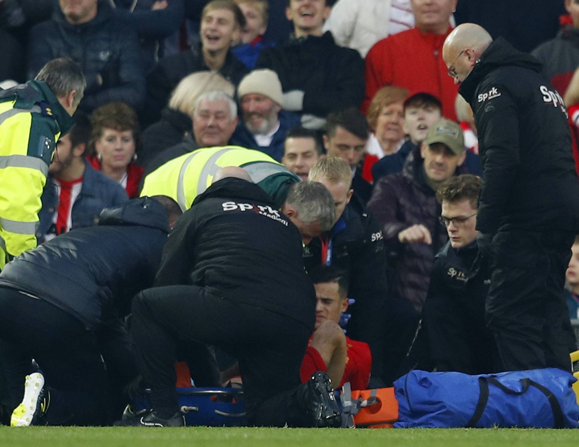 Liverpool's Philippe Coutinho receives medical attention after sustaining an injury