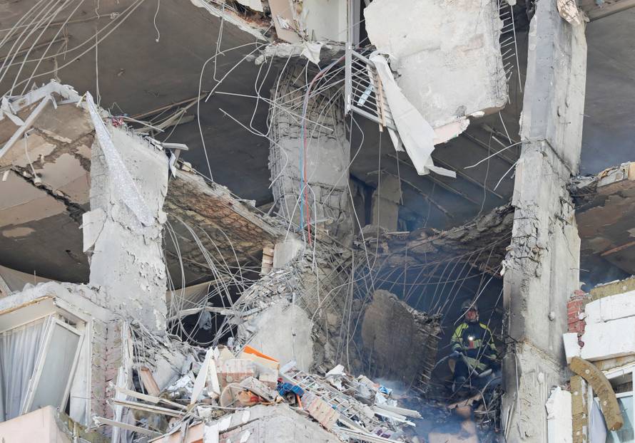 A firefighter works inside an apartment building damaged by recent shelling in Kyiv