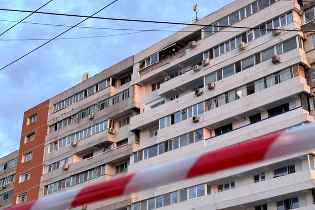 Firefighters work on the site of an explosion at a residential block of flats following a drone hit close to the border with Ukraine