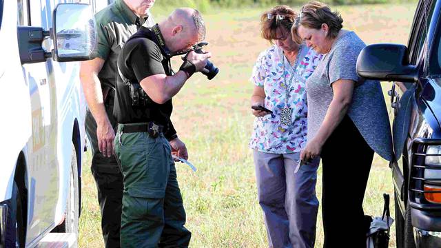 Anderson County sheriff's deputies gather evidence outside of Townville Elementary School in Townville