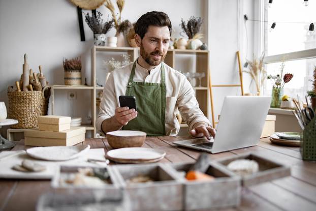 Successful,Guy,Store,Employee,With,Ceramic,Tableware,Shoots,Photos,On
