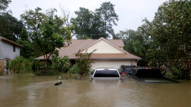 FILE PHOTO:    Houses and cars are seen partially submerged by flood waters from tropical storm Harvey in east Houston