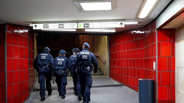 German police officers walk through an underground station as part of increased security measures for the upcoming festive season, near Ebertplatz square in Cologne