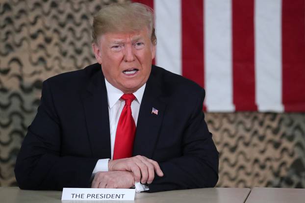 U.S. President Trump speaks to reporters during an unannounced visit to Al Asad Air Base