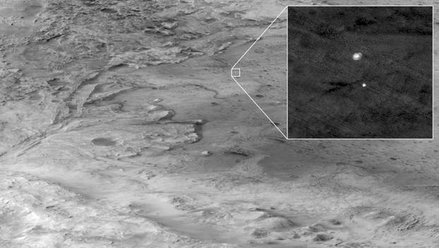 The descent stage holding NASA’s Perseverance rover can be seen falling through the Martian atmosphere