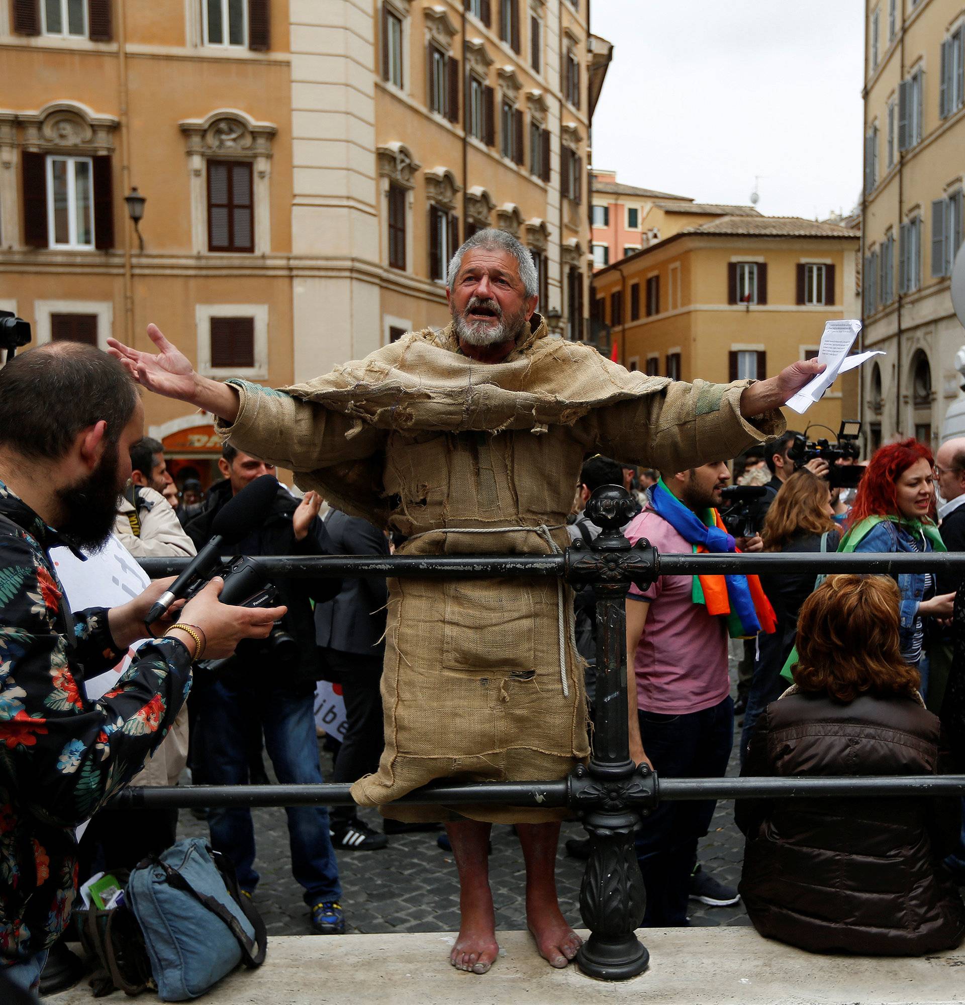 A man protests in front of the Parliament during the final vote on gay and unmarried civil unions at Italy's lower house of Parliament in Rome