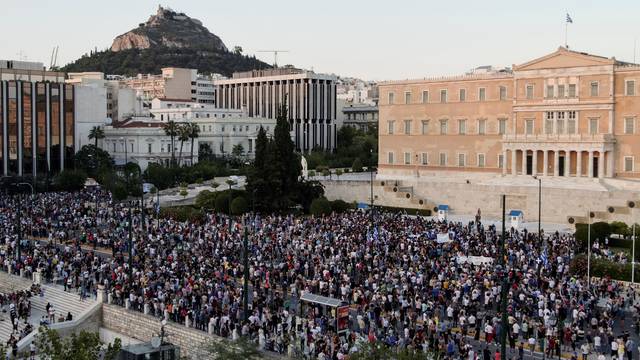 Anti-vaccine protesters take part in a demonstration outside the parliament building in Athens