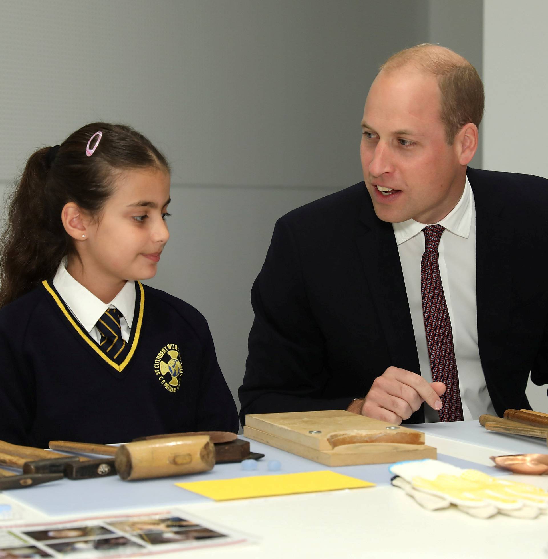 Britain's Prince William joins local school children from St Cuthbert with St Matthias CE Primary School at a copper beating workshop during the official opening of Japan House in London