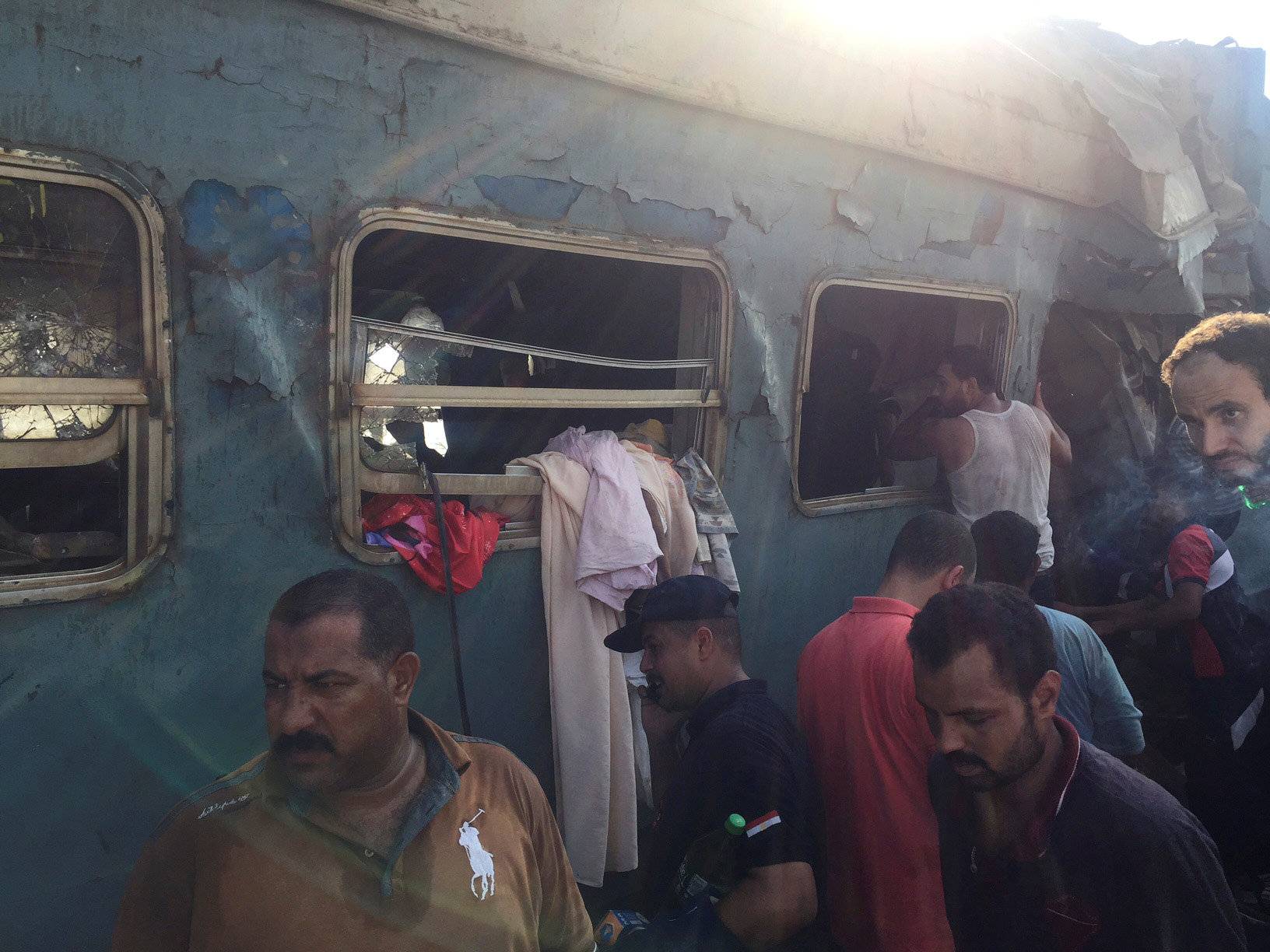 Egyptians search for survivors at the site of a crash where two trains collided near the Khorshid station in Egypt's coastal city of Alexandria