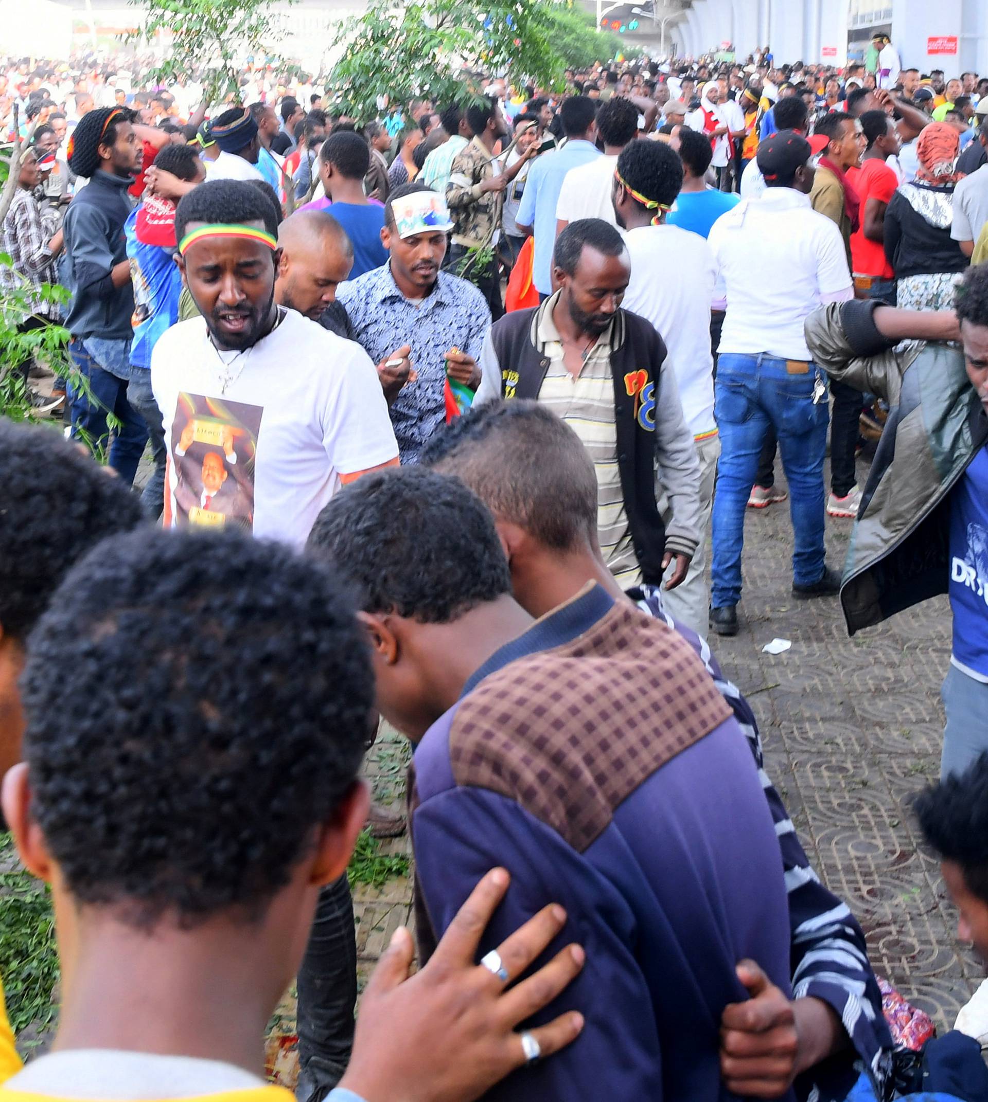 Ethiopians react after an explosion during a rally in support of the new Prime Minister Abiy Ahmed in Addis Ababa
