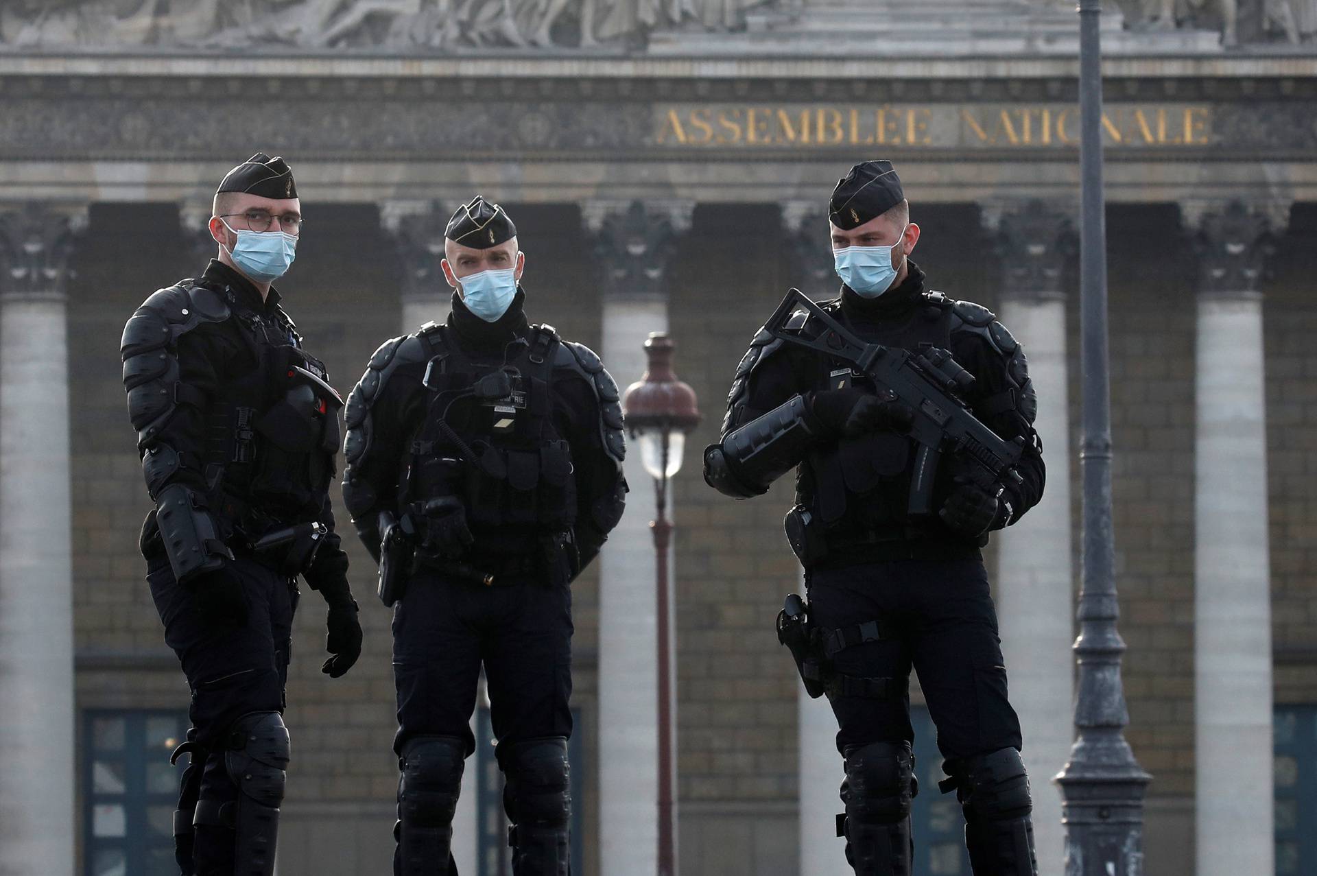 French gendarmes stand guard in front of the National Assembly in Paris