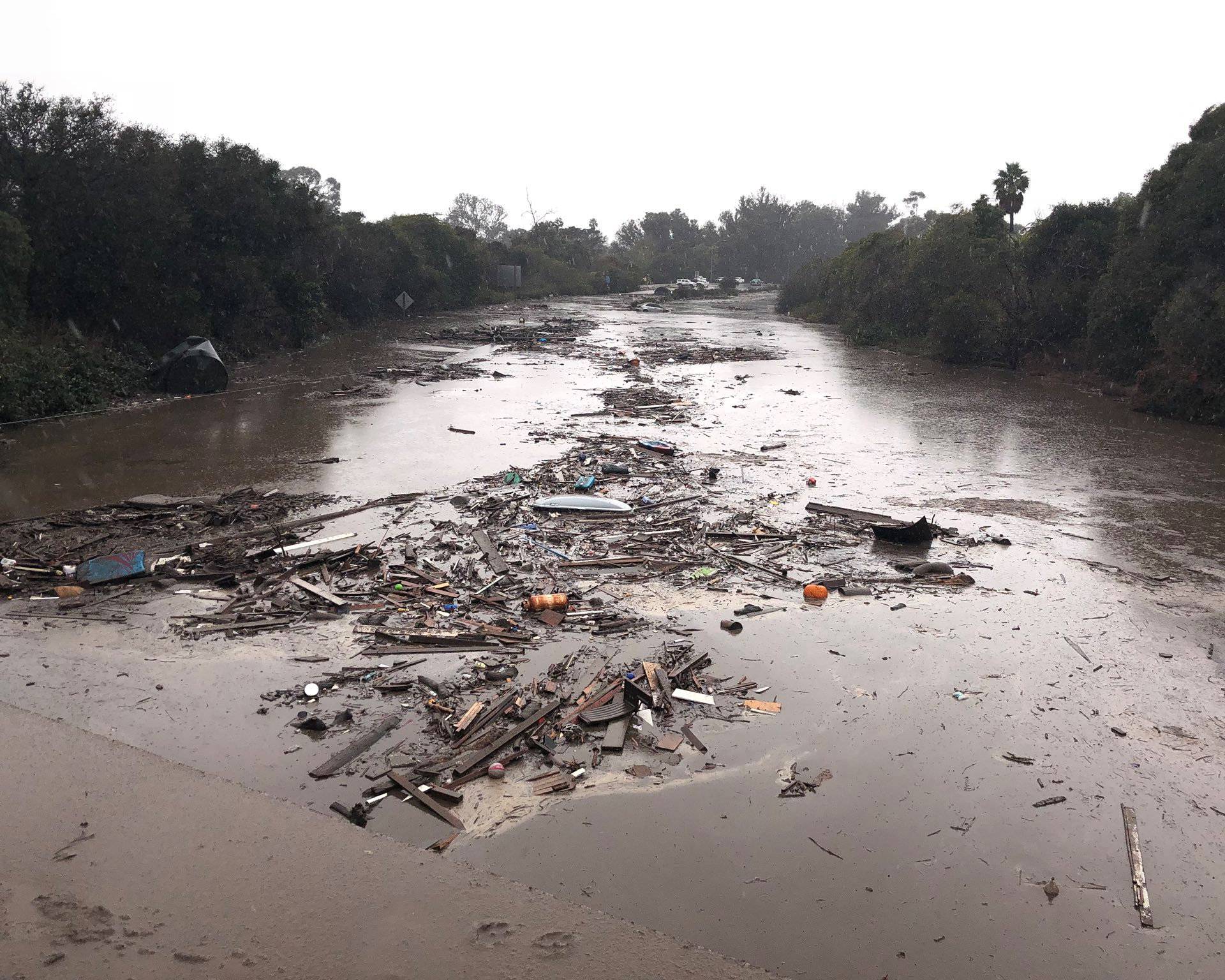 Debris floats in flooded waters on the freeway after a mudslide in Montecito