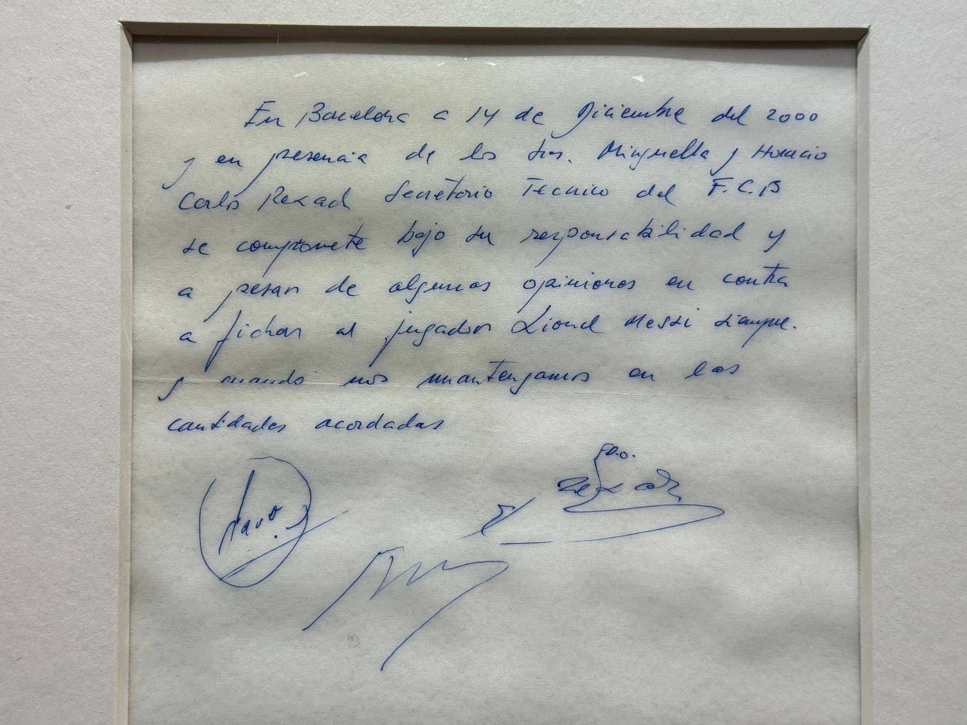 Signed and framed napkin on which soccer club Barcelona promised to sign a 13-year-old Lionel Messi is displayed at the Bonhams auction house in London