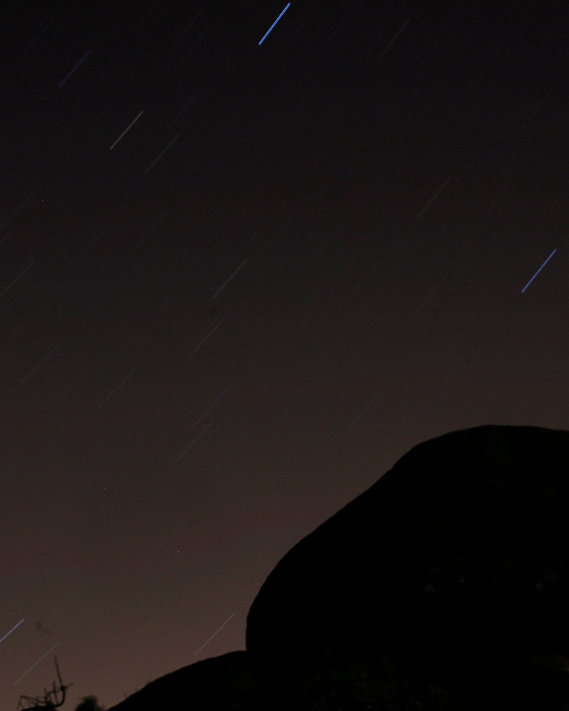 The Perseid meteor shower is pictured in the sky over Las Machotas in San Lorenzo of Escorial, Madrid