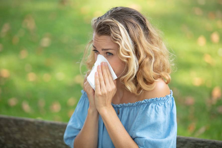 Blond,Woman,Blowing,Nose,Outdoors