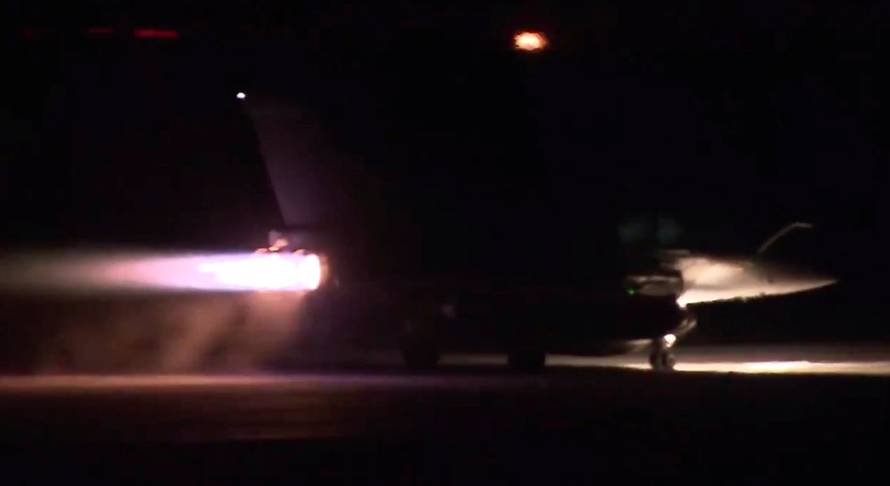 A plane takes off as part of the joint airstrike operation by the British, French and U.S. militaries in Syria