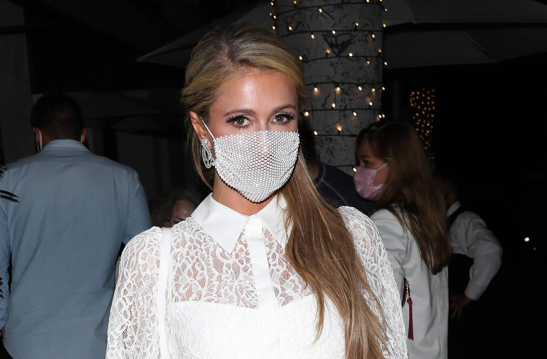 EXCLUSIVE: Paris Hilton stuns in a all white dress as she dines at Madeo restaurant with friends