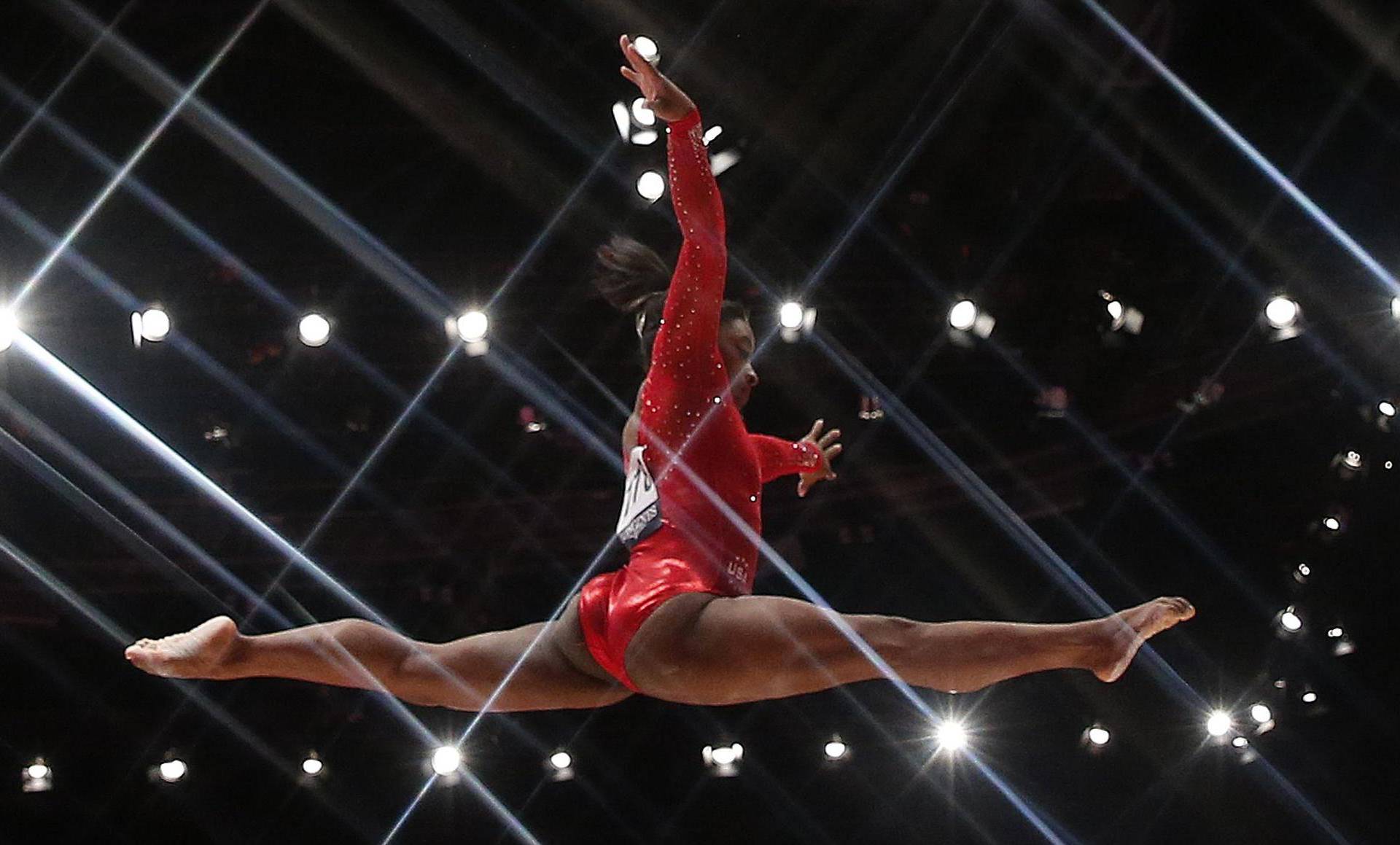 Simone Biles of the U.S competes on the beam during the women's all-round final at the World Gymnastics Championships in Glasgow