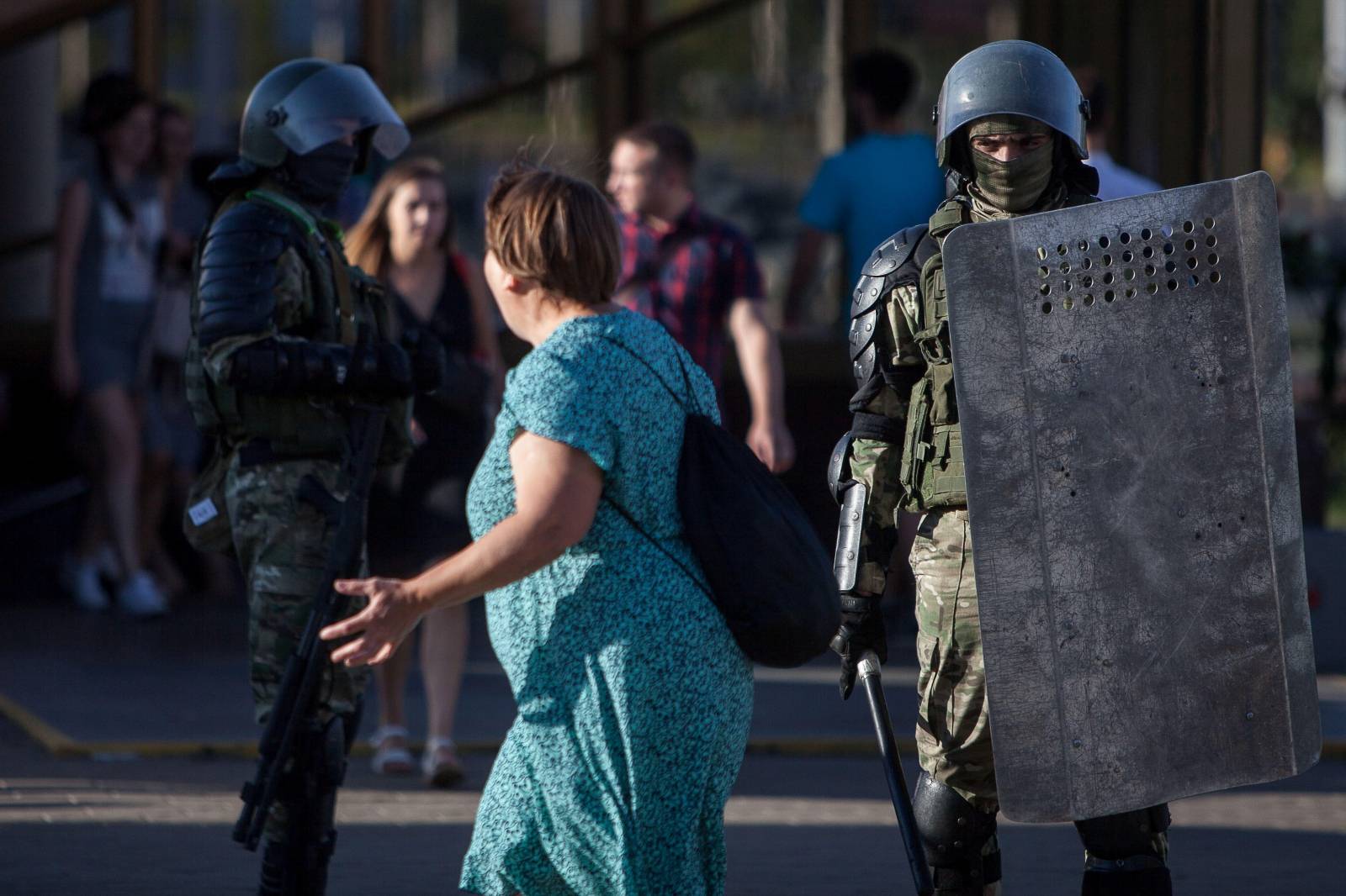 Law enforcement officers stand guard near the site where a protester died during a rally following the presidential election in Minsk