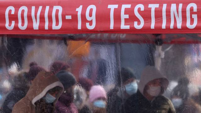 FILE PHOTO: People queue to be tested for COVID-19 in Times Square in Manhattan, New York City