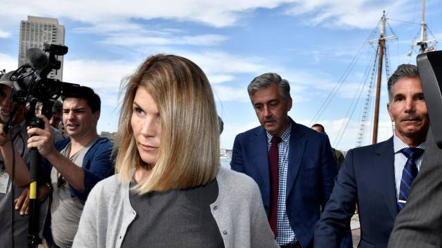 FILE PHOTO: Actress Lori Loughlin, and her husband, fashion designer Mossimo Giannulli leave the federal courthouse after a hearing on charges in a nationwide college admissions cheating scheme in Boston