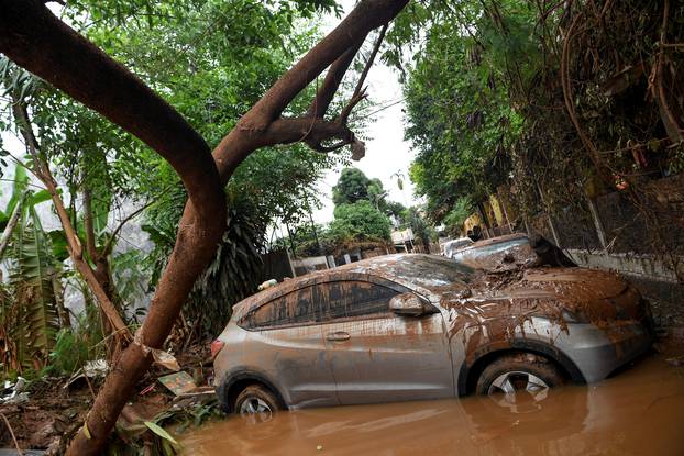 Cars damaged by floods following heavy rains sit in floodwater at residential area in Bintaro, Jakarta