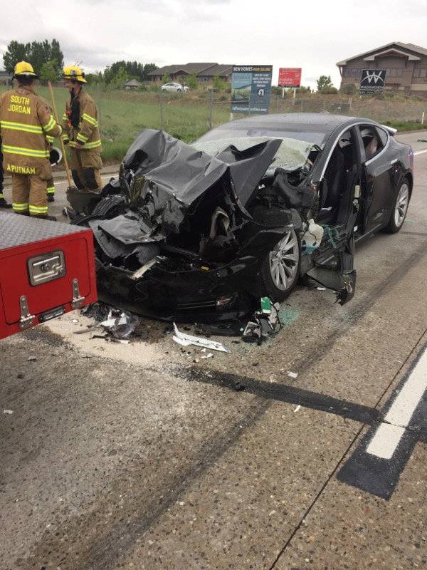 A Tesla Model S is seen after it hit the back of a mechanic truck in South Jordan