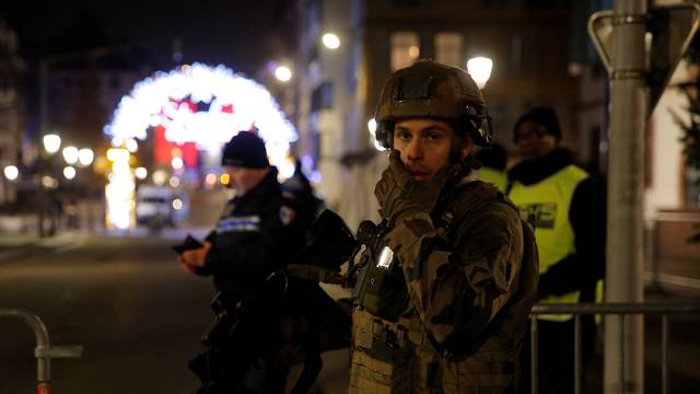 Police officers secure a street and the surrounding area after a shooting in Strasbourg