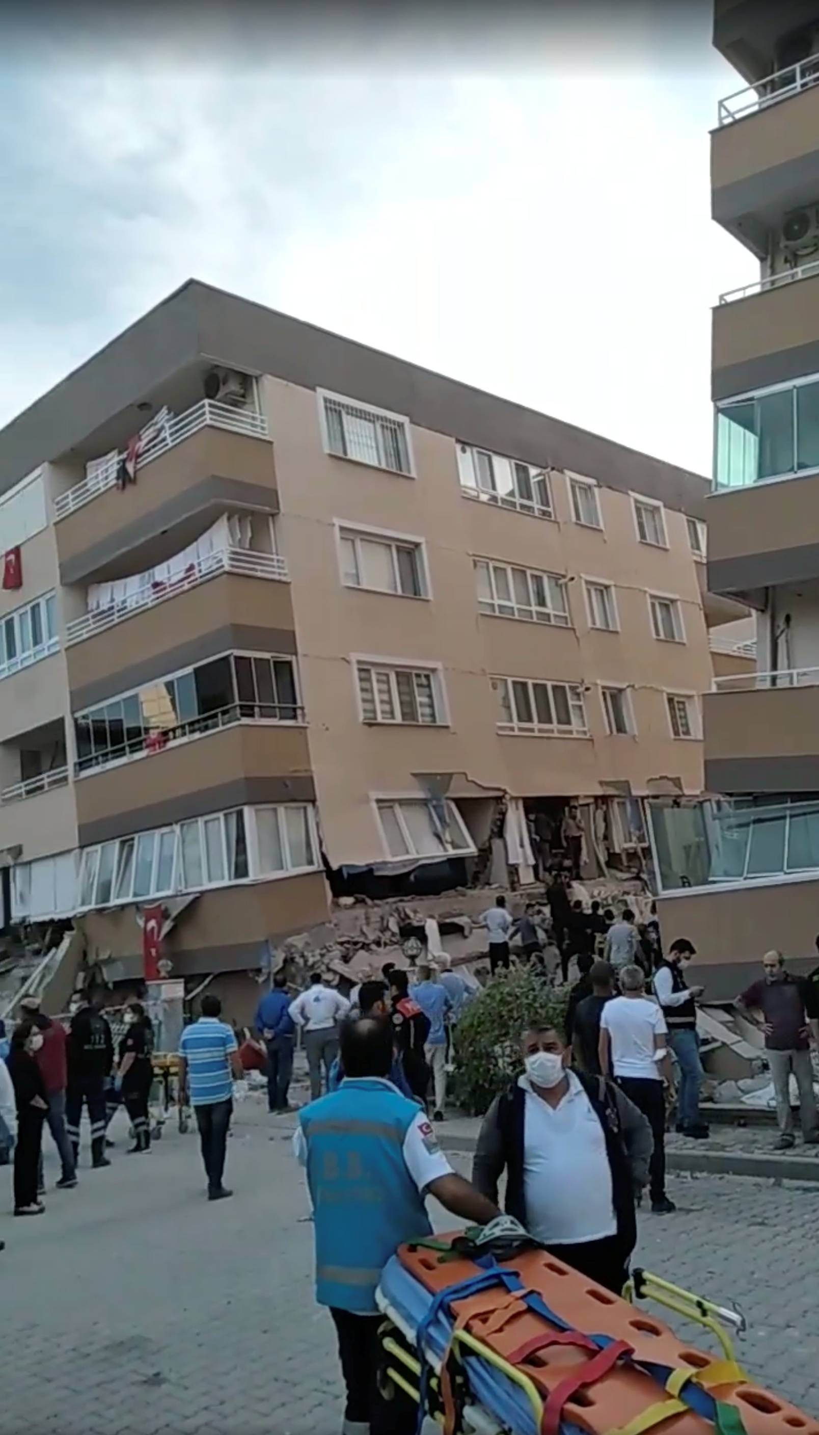 Rescue operations take place around subsided and collapsed buildings after a strong earthquake struck the Aegean Sea, in the coastal province of Izmir