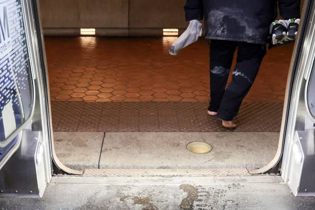 Commuters make their way though snow and ice in the aftermath of a winter storm in Washington