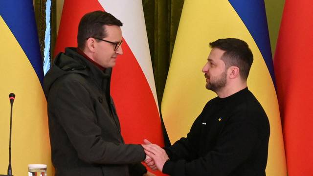 FILE PHOTO: Ukraine's President Zelenskiy and Polish PM Morawiecki shake hands during a news briefing in Kyiv