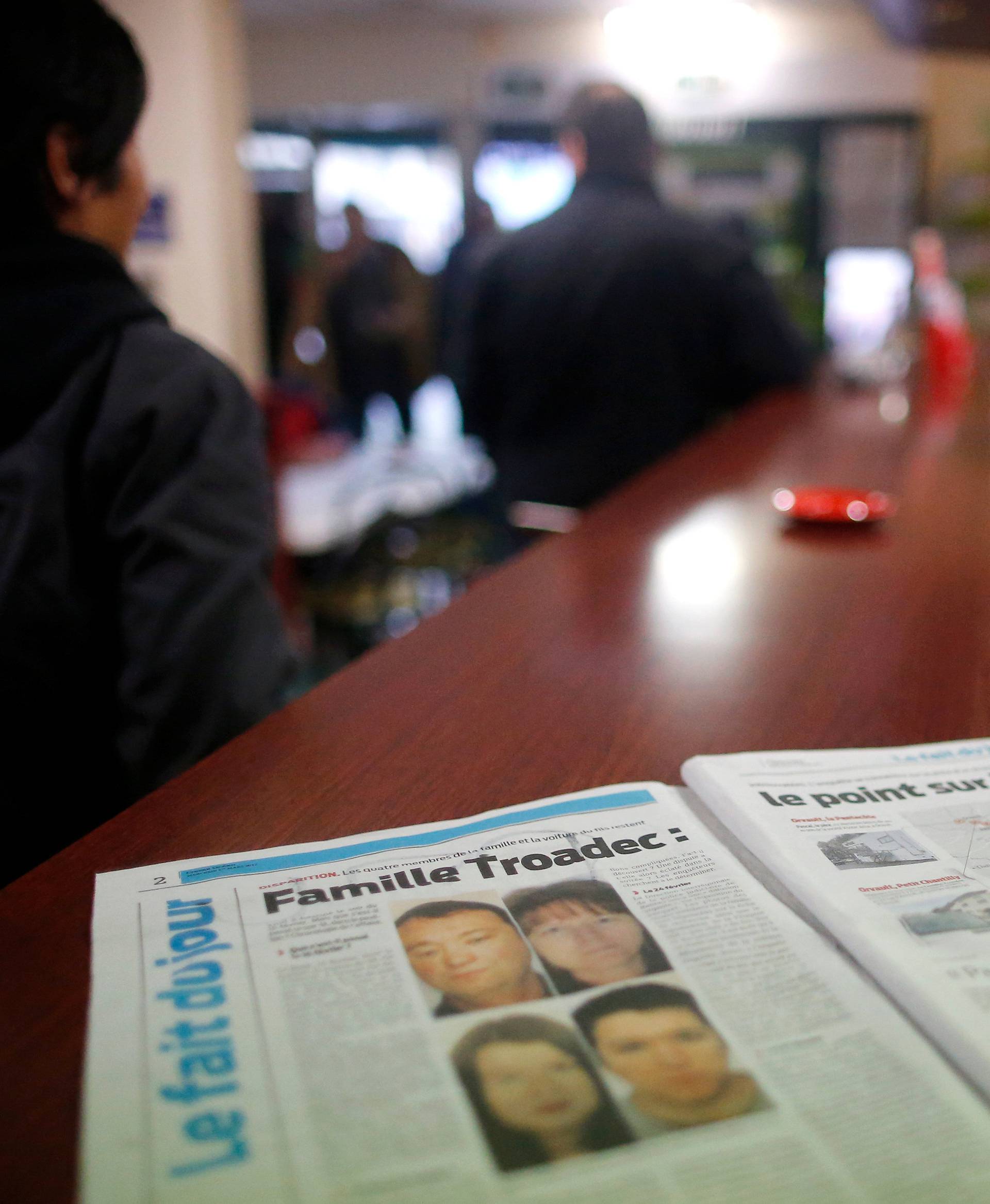 A newspaper sits on the counter of a neighborhood bar near the house of the Troadec family in Orvault