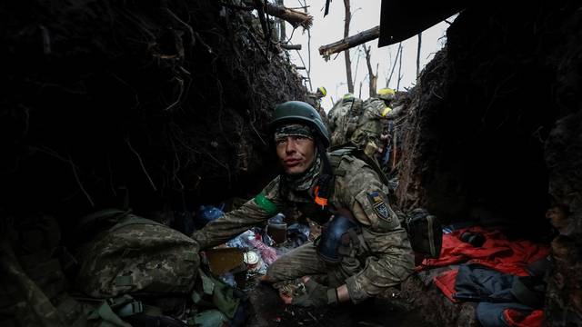 Ukrainian servicemen rest after a fight near the front line city of Bakhmut