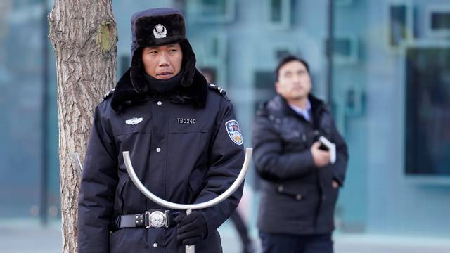 Security personnel stand guard outside the Joy City Mall in the Xidan district after a knife attack, in Beijing